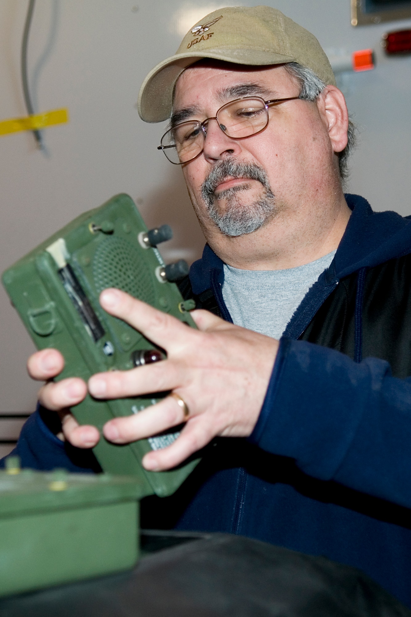 GRISSOM AIR RESERVE BASE, Ind. -- Bob Wydock, 434th Civil Engineer Squadron base deputy emergency manager, opens an M-42 alarm to check for batteries. The alarm is used to sound the detection of chemical agents in a field environment. (U.S. Air Force photo/Tech. Sgt. Douglas Hays)