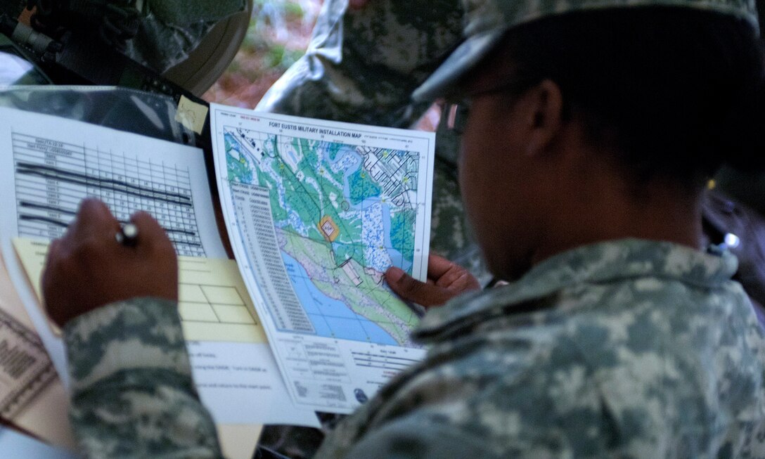 U.S. Army Sgt. 1st Class Tomekia Branch, 689th Rapid Port Opening Element distribution platoon sergeant, plots checkpoint locations during the land navigation portion of the brigade’s Best Warrior Competition at Fort Eustis, Va., March 27, 2013. Each participant was tasked to find four unique points, the first with a Defense Advanced GPS Receiver and the final three with a compass. (U.S. Air Force photo by Airman 1st Class R. Alex Durbin/Released)