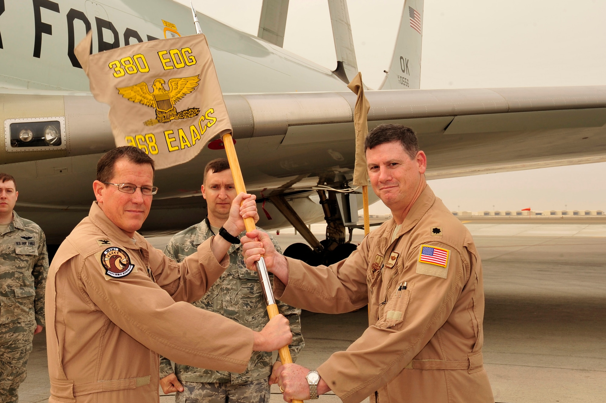 U.S. Air Force Col. Ronald Henry, 380th Expeditionary Operations Group commander, and Lt. Col. Peter Mykytyn, 968th Expeditionary Airborne Air Control Squadron commander, uncase the unit flag during an activation ceremony for the 968 EAACS at an undisclosed location in Southwest Asia Mar. 25, 2013. The activation of this unit assists in the transition of an enduring unit and for the first time will have a one-year commander supported by units from Pacific Air Forces and Air Combat Command. (U.S. Air Force photo by Tech. Sgt. Christina M. Styer/Released)  