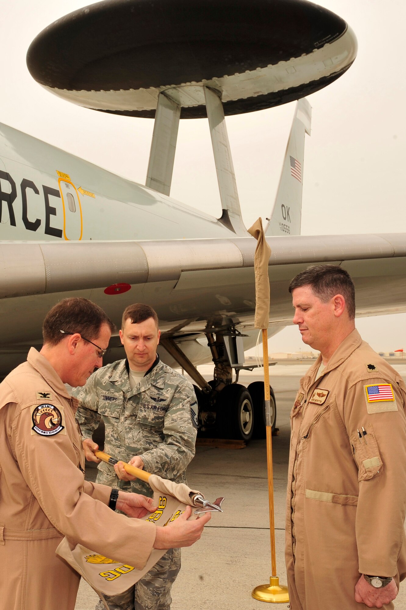 U.S. Air Force Lt. Col. Peter Mykytyn, 968th Expeditionary Airborne Air Control Squadron commander, assumes command of the 968 EAACS from Col. Ronald Henry, 380th Expeditionary Operations Group commander, during an activation ceremony for the 968 EAACS at an undisclosed location in Southwest Asia Mar. 25, 2013. The activation of this unit assists in the transition of an enduring unit and for the first time will have a one-year commander supported by units from Pacific Air Forces and Air Combat Command. (U.S. Air Force photo by Tech. Sgt. Christina M. Styer/Released)  