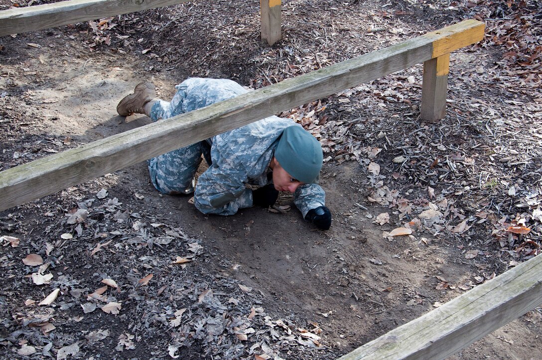 U.S. Army Sgt. Claribel Lopez Feliciano, 688th Rapid Port Opening Element transportation management coordinator, navigates the low rail obstacle during the obstacle course portion of the 597th Transportation Brigade’s annual Best Warrior Competition March 28, 2013 at Fort Eustis, Va. Lopez Feliciano won Brigade Noncommissioned Officer of the Year, earning an Army Achievement Medal. (U.S. Air Force photo by Tech. Sgt. April Wickes/RELEASED)
