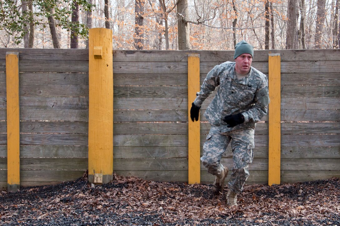 U.S. Army Spc. Carl Gahry, 689th Rapid Port Opening Element transportation management coordinator, completes the wall obstacle during the obstacle course portion of the 597th Transportation Brigade’s annual Best Warrior Competition March 28, 2013 at Fort Eustis, Va. Soldiers were challenged with more than ten obstacles during this portion of the competition. (U.S. Air Force photo by Tech. Sgt. April Wickes/RELEASED)