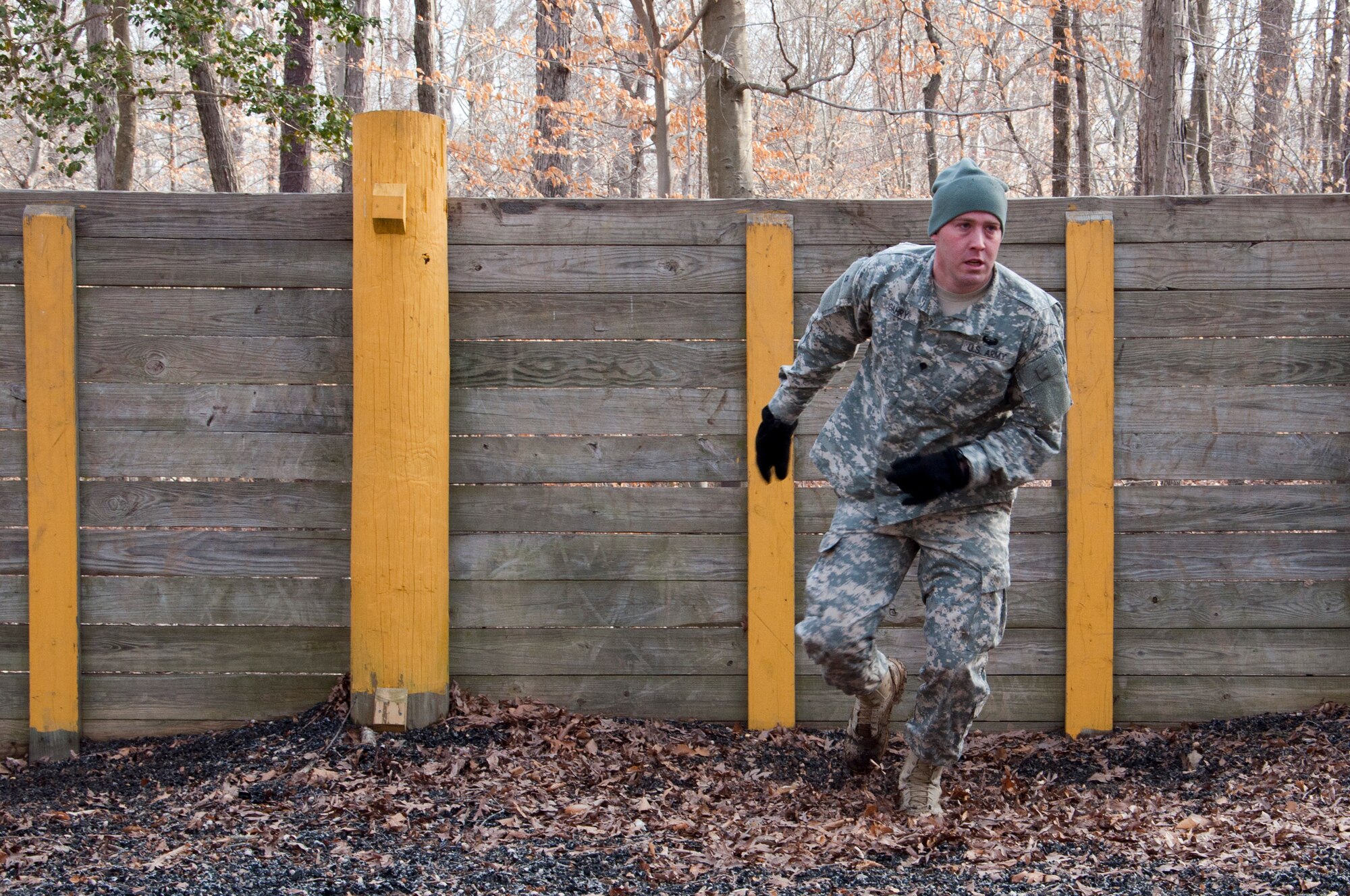 U.S. Army Spc. Carl Gahry, 689th Rapid Port Opening Element transportation management coordinator, completes the wall obstacle during the obstacle course portion of the 597th Transportation Brigade’s annual Best Warrior Competition March 28, 2013 at Fort Eustis, Va. Soldiers were challenged with more than ten obstacles during this portion of the competition. (U.S. Air Force photo by Tech. Sgt. April Wickes/RELEASED)