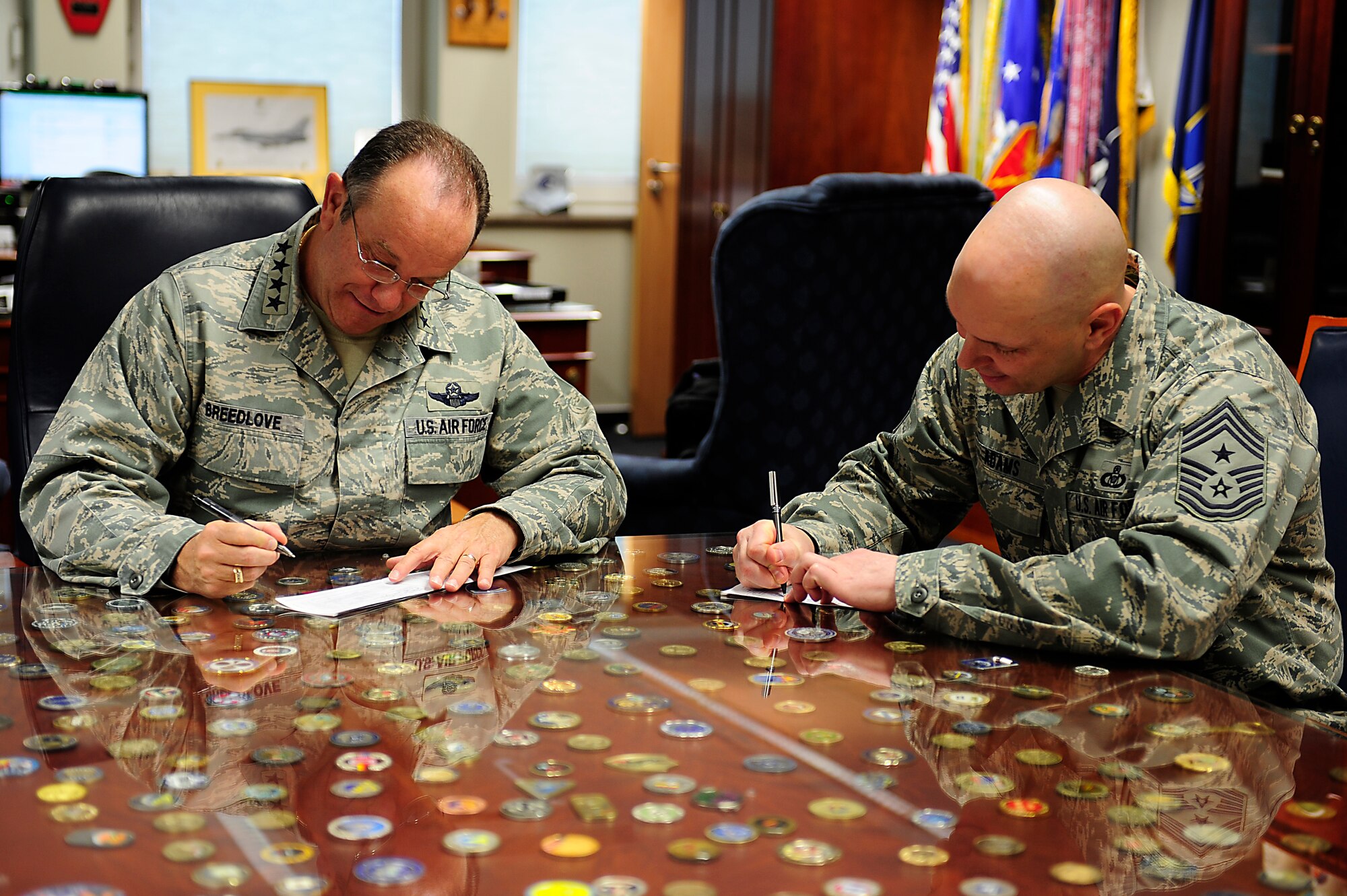 Gen. Philip M. Breedlove, U.S. Air Forces in Europe and Air Forces Africa commander (left), and USAFE-AFAFRICA Command Chief Craig A. Adams, complete their Air Force Assistance Fund contribution forms April 2 in the commander’s office here. The AFAF was established to provide assistance through donations to organizations charged with helping Airmen and their families. (U.S. Air Force photo by Airman 1st Class Holly Cook)
