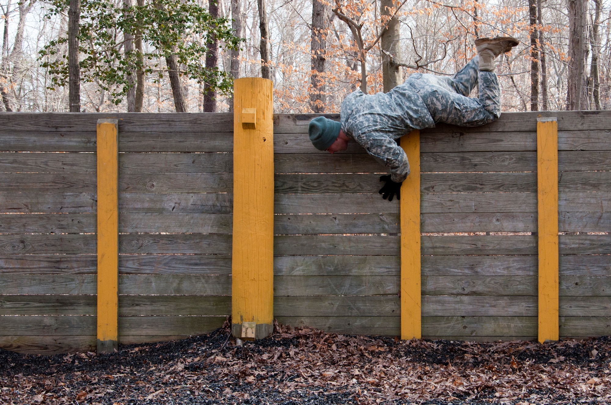U.S. Army Spc. Carl Gahry, 689th Rapid Port Opening Element transportation management coordinator, hops over a wall obstacle during the obstacle course portion of the 597th Transportation Brigade’s annual Best Warrior Competition March 28, 2013 at Fort Eustis, Va. Eight soldiers competed in the competition testing their physical and mental strength. (U.S. Air Force photo by Tech. Sgt. April Wickes /RELEASED)