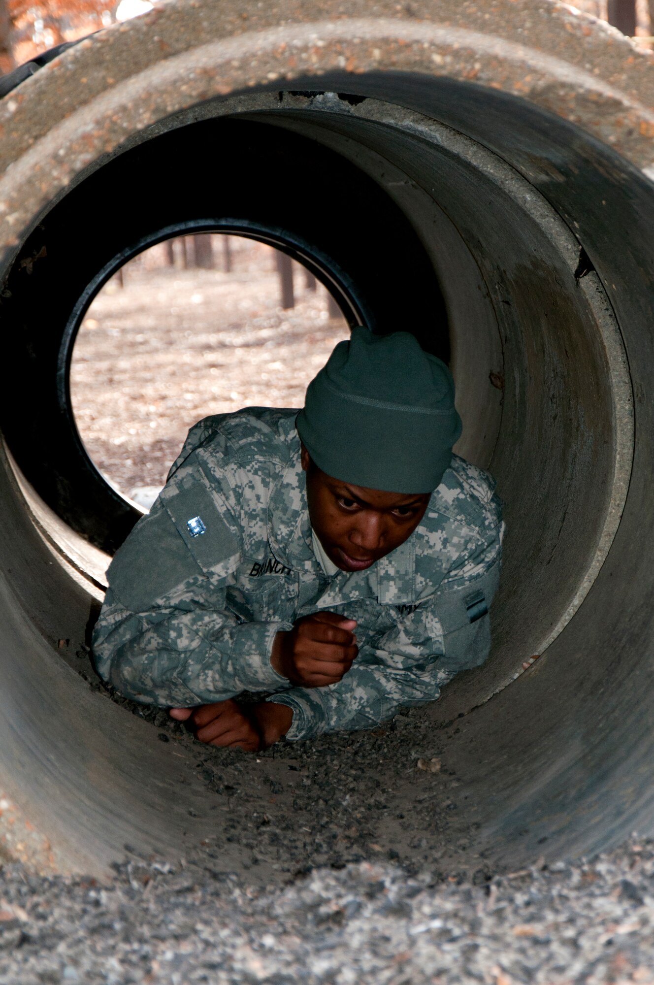 U.S. Army Sgt. 1st Class Tomekia Branch, 689th Rapid Port Opening Element distribution platoon sergeant, crawls through the tunnel obstacle during the obstacle course portion of the 597th Transportation Brigade’s annual Best Warrior Competition March 28, 2013 at Fort Eustis, Va. Soldiers were challenged with more than ten obstacles during this portion of the competition. (U.S. Air Force photo by Tech. Sgt. April Wickes/RELEASED)