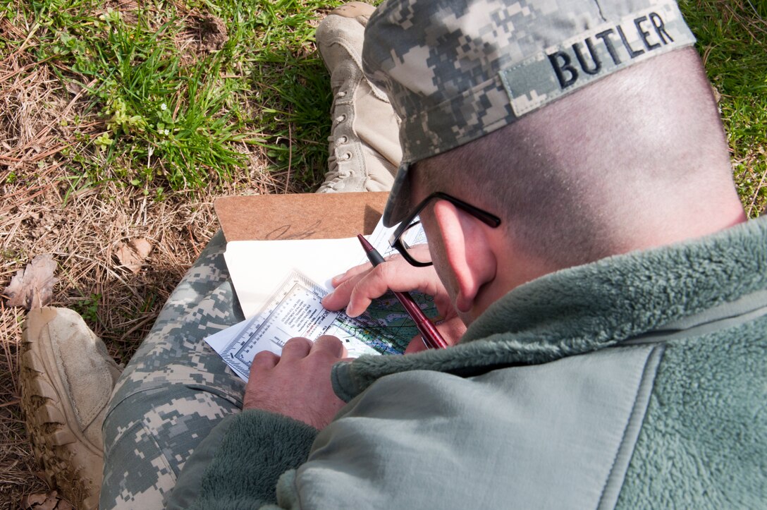 U.S. Army Spc. Timothy Butler, 688th Rapid Port Opening Element movement specialist, plots his way points during the land navigation portion of the 597th Transportation Brigade’s annual Best Warrior Competition March 27, 2013 at Fort Eustis, Va. Competitors had to map and their course and find their way to four way points using a Defense Advanced GPS Receiver and compass. (U.S. Air Force photo by Tech. Sgt. April Wickes /RELEASED)