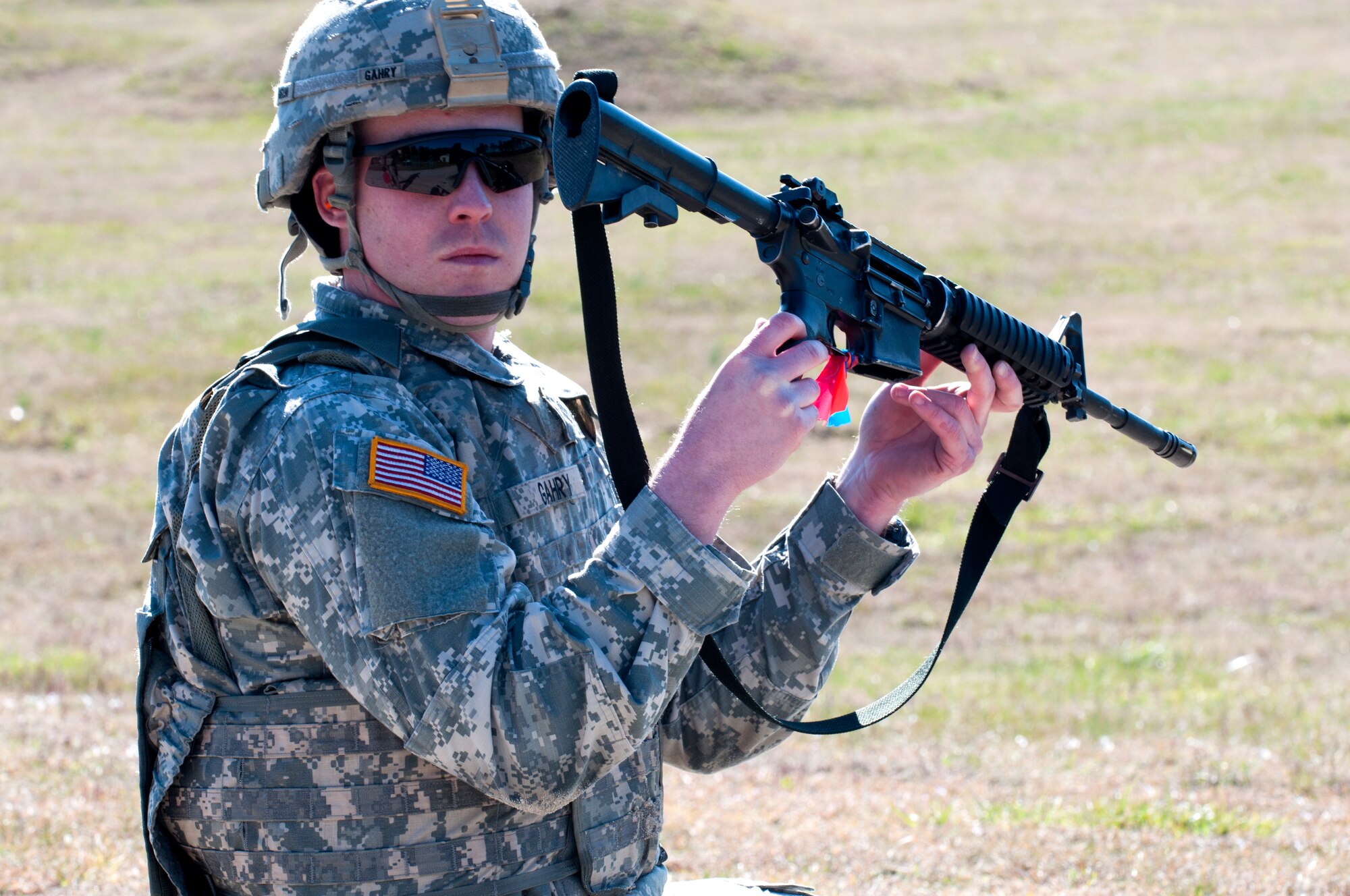 U.S. Army Spc. Carl Gahry, 689th Rapid Port Opening Element transportation management coordinator, holds up his rifle to signify the completion of the rifle qualification portion of the 597th Transportation Brigade’s annual Best Warrior Competition March 27, 2013 at Fort Eustis, Va. The competition identifies the brigade’s best Soldiers, sending them up to compete at the Surface Deployment and Distribution Command-level competition. (U.S. Air Force photo by Tech. Sgt. April Wickes /RELEASED)
