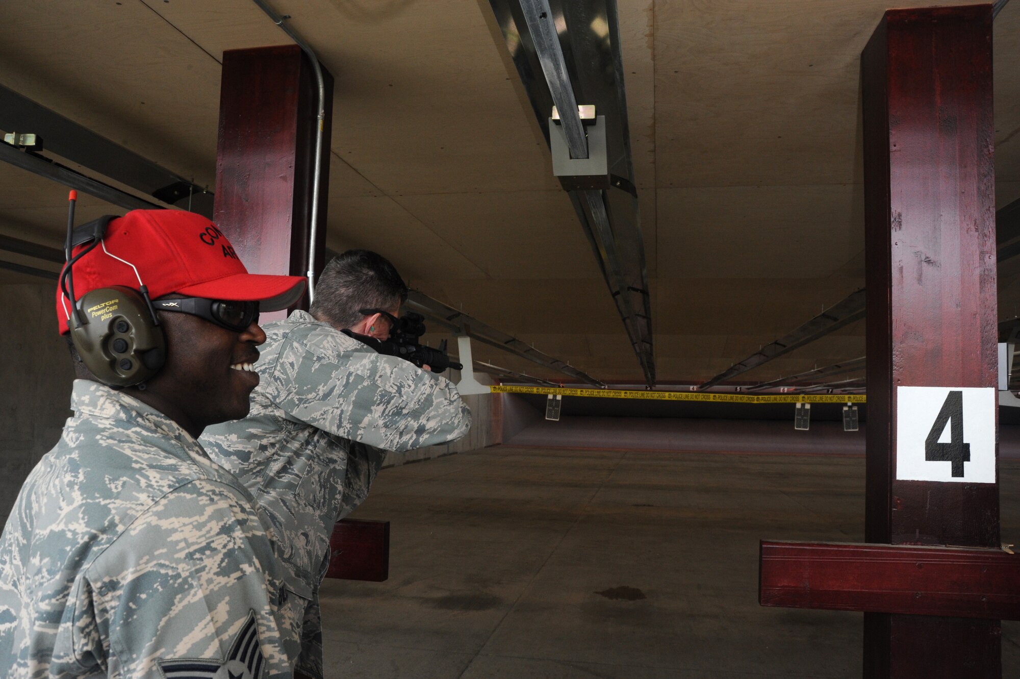 Col. Chris Craige, 39th Air Base Wing commander fires at a ribbon as Staff Sgt. Raymond Billups, 39th Security Forces Squadron combat arms instructor, watches during the reopening ceremony for the Combat Arms Training and Maintenance range April 1, 2013, at Incirlik Air Base, Turkey. The renovated facility will be used to maintain readiness and qualifications of security forces and deploying service members. (U.S. Air Force photo by Staff Sgt. Eric Summers Jr./Released)