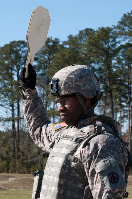U.S. Army Sgt. Keith McDonald, 597th Transportation Brigade training noncommissioned officer, signals to the tower that Range Three is clear and ready during the rifle qualification portion of brigade’s annual Best Warrior Competition March 27, 2013 at Fort Eustis, Va. Eight Soldiers competed in the week-long competition, testing their physical and mental strength. (U.S. Air Force photo by Tech. Sgt. April Wickes/RELEASED)