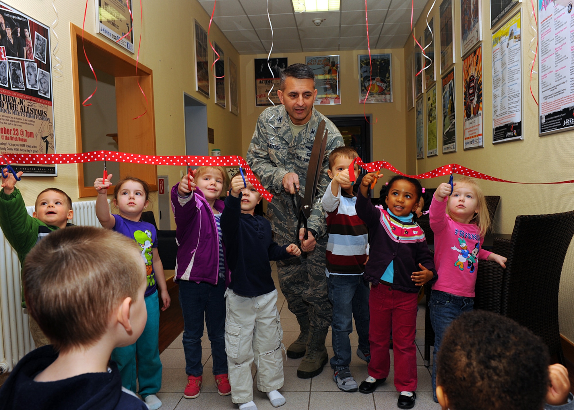 SPANGDAHLEM AIR BASE, Germany -- U.S. Air Force Col. David Julazadeh, 52nd Fighter Wing commander from Chillacothe, Ill., cuts a ribbon April 2, 2013, at the opening ceremony for Spangdahlem Air Base’s new child playroom. Children helped Julazadeh cut the ribbon before entering the playroom for first-hand testing. The $4,000 project includes the renovation to the room, a seating area for parents and numerous playroom items. (U.S. Air Force photo by Staff Sgt. Daryl Knee/Released)