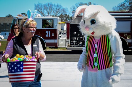 Janice Ryan, Forest City Communities dispatcher and the Easter Bunny prepare to hand out Easter eggs during the opening of the new Community Center March 29, 2013, at Joint Base Charleston – Air Base, S.C. The community center is 5,696 square feet and includes a business center, a fitness center, a kitchen and activity center, showers, locker rooms and two housing management offices. (U.S. Air Force photo/Staff Sgt. Anthony Hyatt)