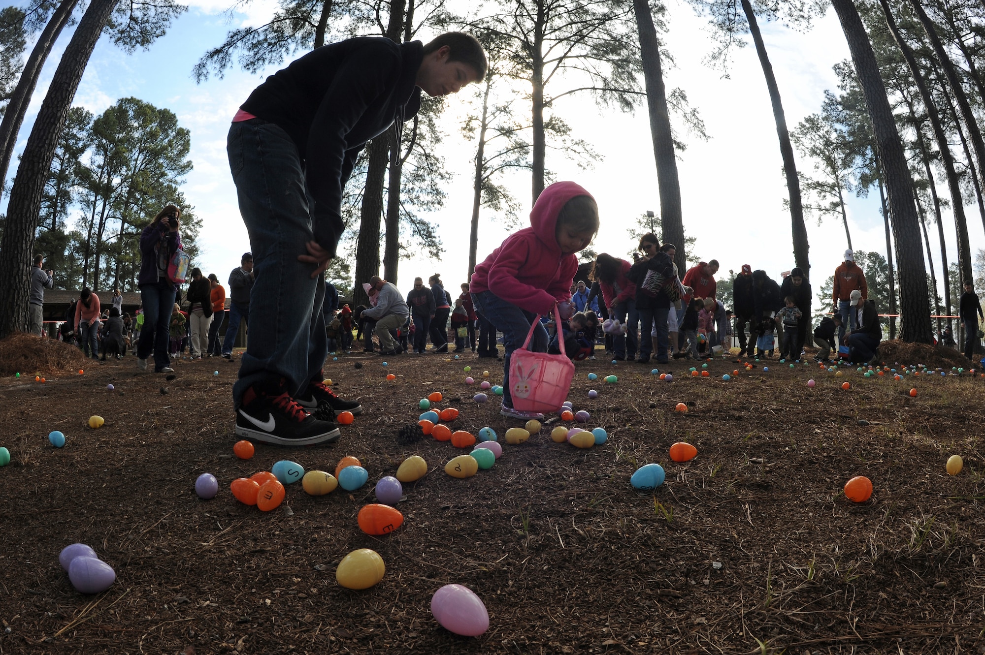 Elleigh Molter, 3, picks up an Easter egg with her uncle Weston Molter, 16, during the Easter Egg Hunt at Debden Park on Seymour Johnson Air Force Base, N.C., Mar. 30, 2013. More than 250 kids found themselves competing against one another, scavenging the park grounds for Easter eggs. (U.S. Air Force photo/Airman 1st Class John Nieves Camacho/Released)