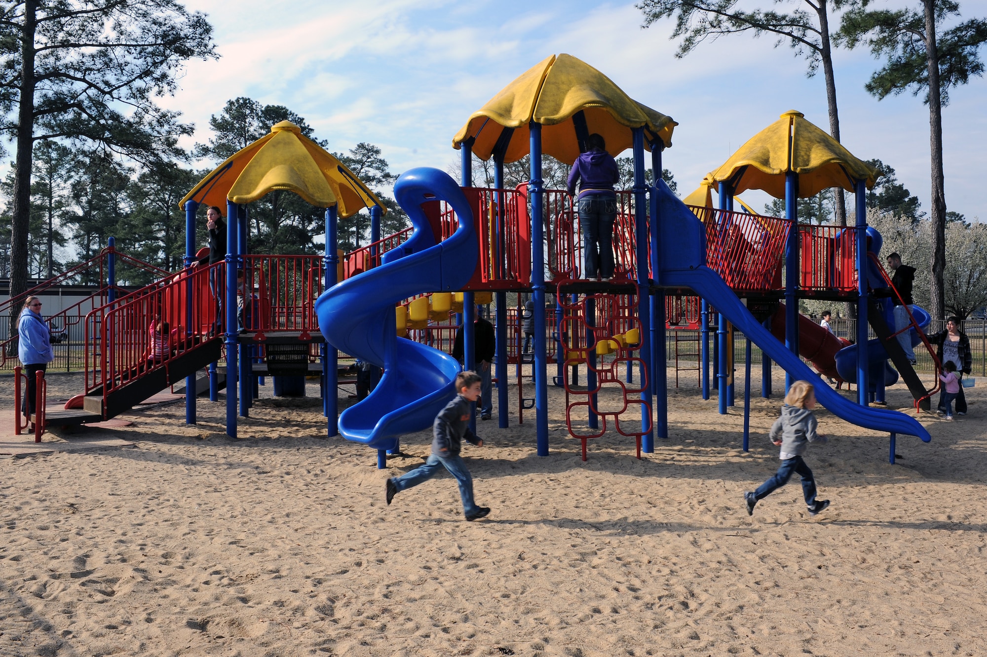 Children run around the playground during the Easter Egg Hunt event at Debden Park on Seymour Johnson Air Force Base, N.C., Mar. 30, 2013. Children of all ages were invited to come out and engage in a variety of festivities surrounding the Easter holiday. (U.S. Air Force photo/Airman 1st Class John Nieves Camacho/Released)