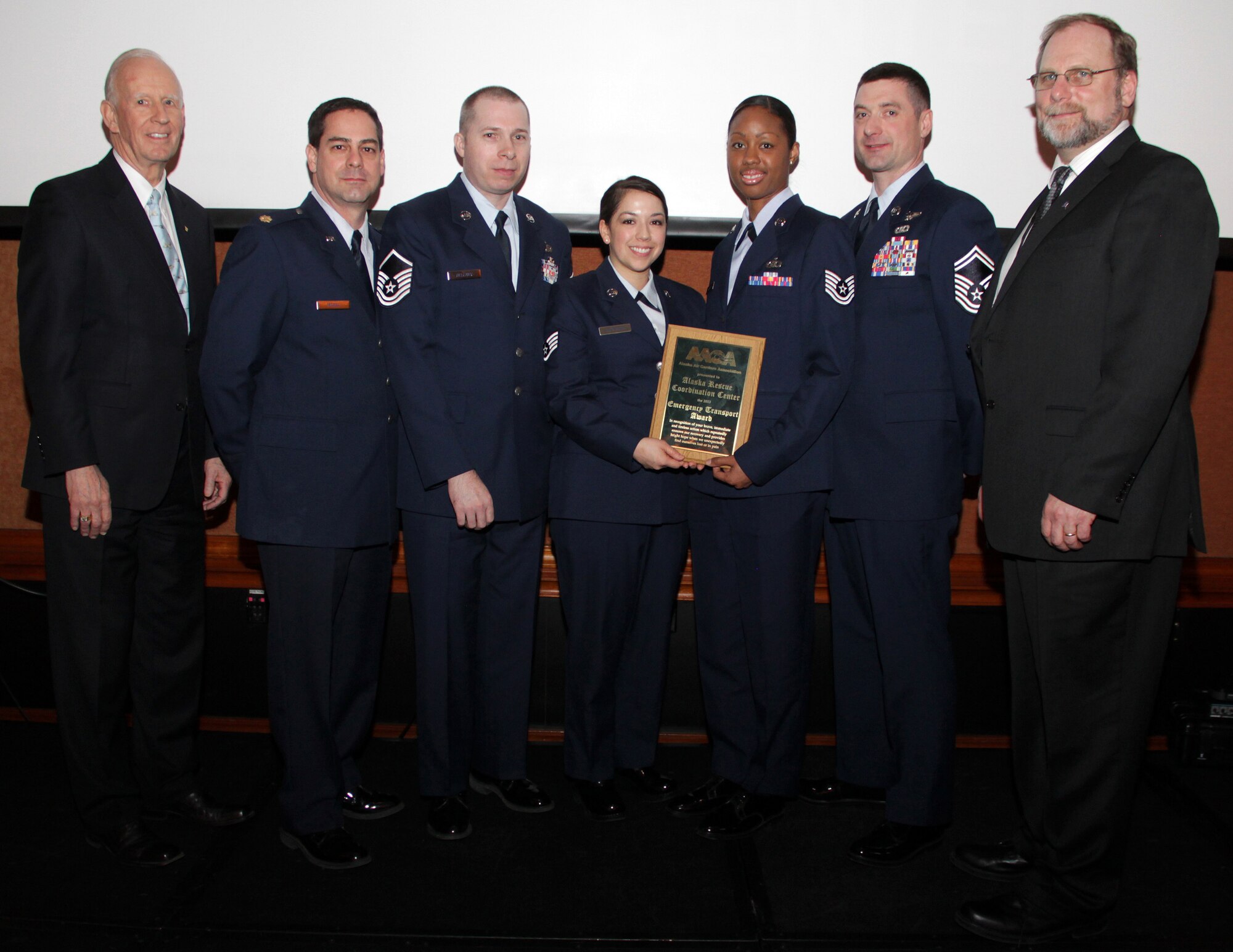 AACAward Alaska Air National Guardsmen with the 11th Air Force Rescue Coordination Center accept the 2013 Alaska Air Carriers Association Emergency Response Award Feb. 13, 2013. The RCC was recognized for its outstanding contribution to commercial aviation safety and its response to numerous aviation incidents throughout the state. Pictured left to right are: Robert Lewis, FAA Alaska Region Administrator; Maj. John Morse, RCC deputy director; Master Sgt. Ken Bellamy, RCC controller; Staff Sgt. Tiffany Alexander, RCC controller; Tech Sgt. Michelle Gillett, RCC controller; Senior Master Sgt. Rob Carte, RCC superintendent, and Mike Stedman, president of Alaska Air Carriers Association. Photo: Rob Stapelton, Medallion Foundation 