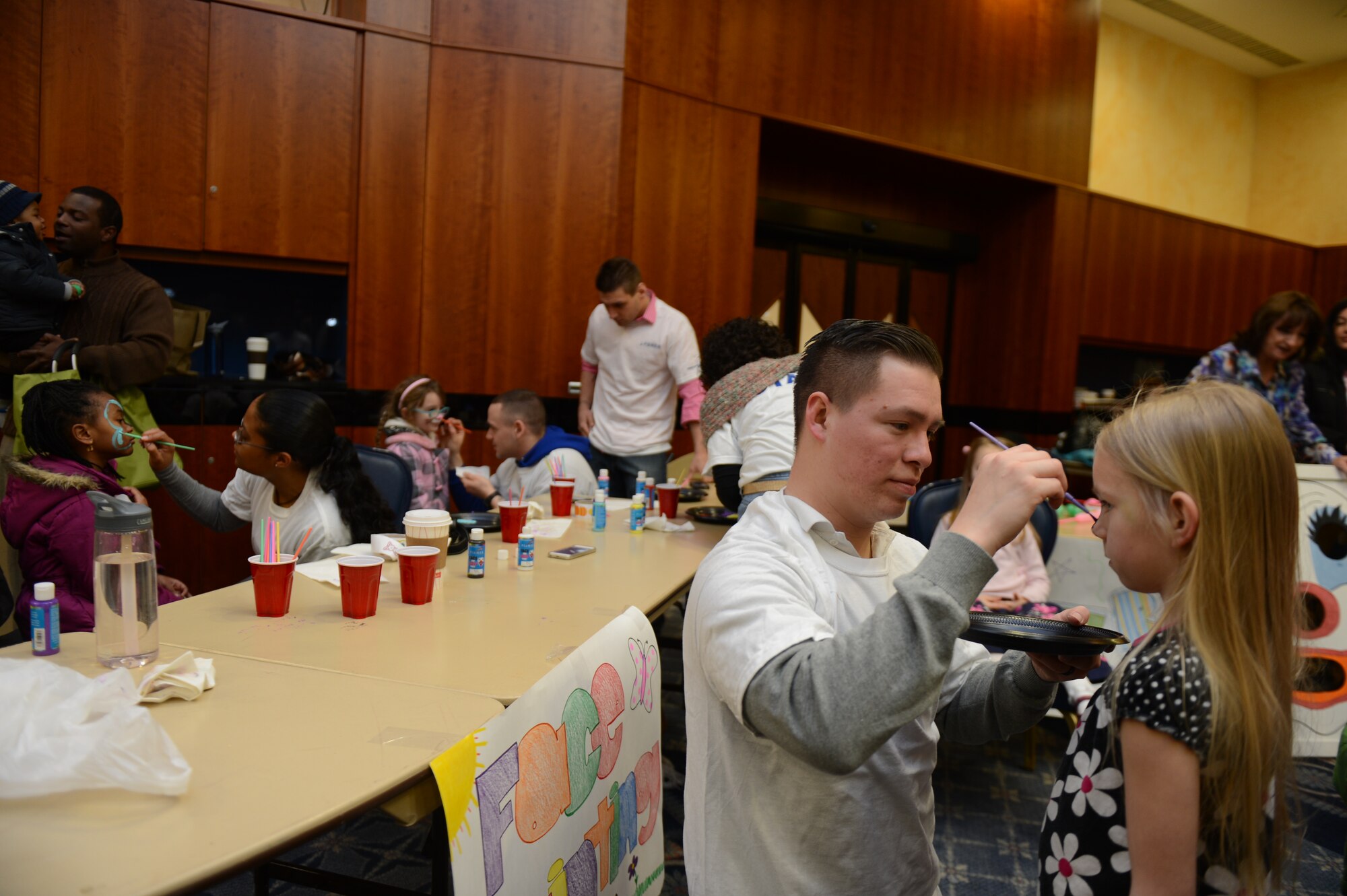 SPANGDAHLEM AIR BASE, Germany – Volunteers paint children’s faces during an Easter celebration as part of the Month of the Military Child inside Club Eifel March 30, 2013. The Month of the Military Child recognizes the contribution that military children make as their parents serve in the military. (U.S. Air Force photo by Airman 1st Class Gustavo Castillo/Released) 