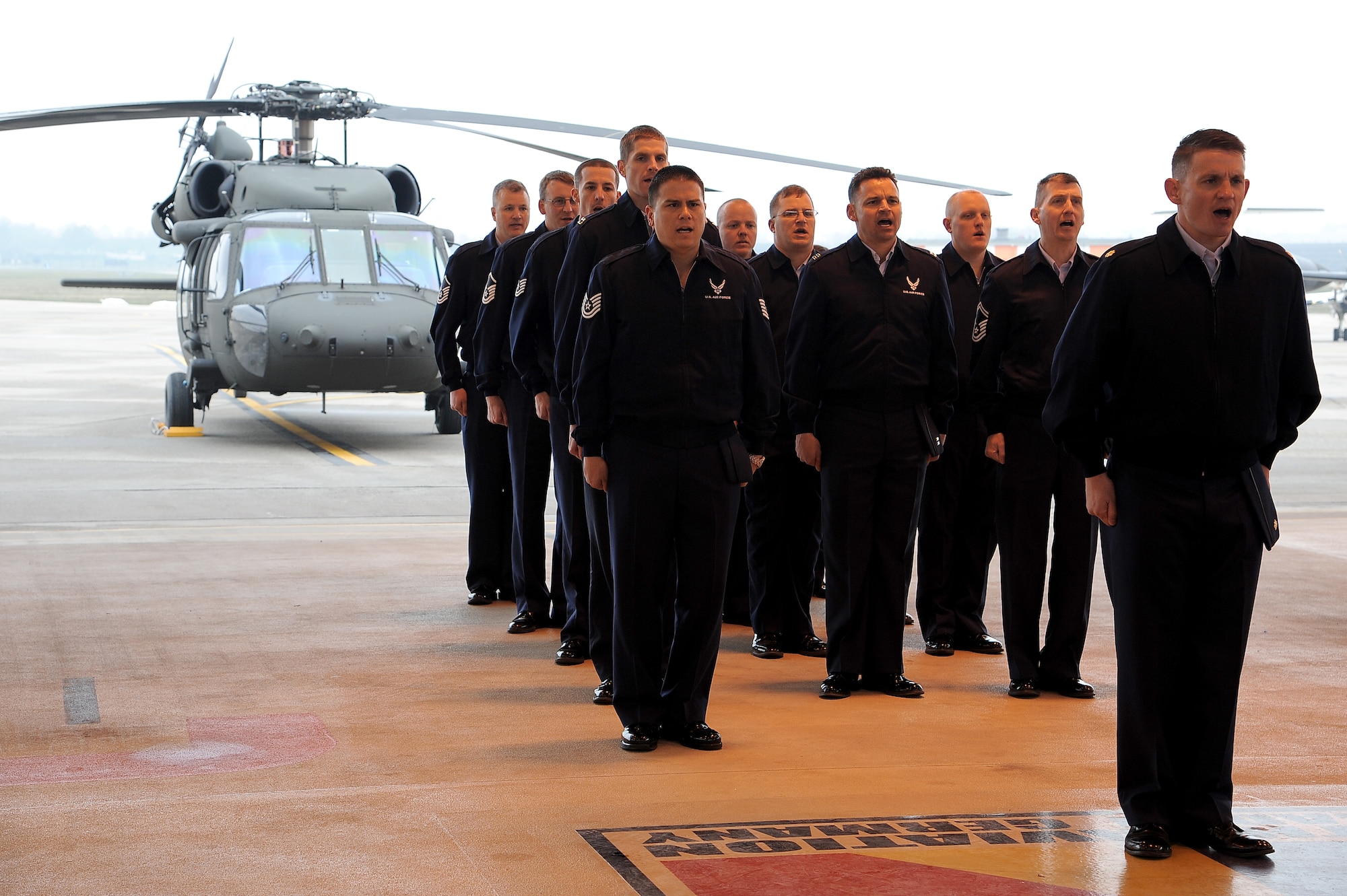 Airmen from the 7th Weather Squadron sing the Air Force song during an official ceremony, March 28, 2013, Weisbaden, Germany. The 7th WS retired the colors from the detachment located in Heidelberg. The 7th WS ran a 55 mile relay while transporting the colors to Weisbaden. (U.S. Air Force photo/Airman 1st Class Hailey Haux)