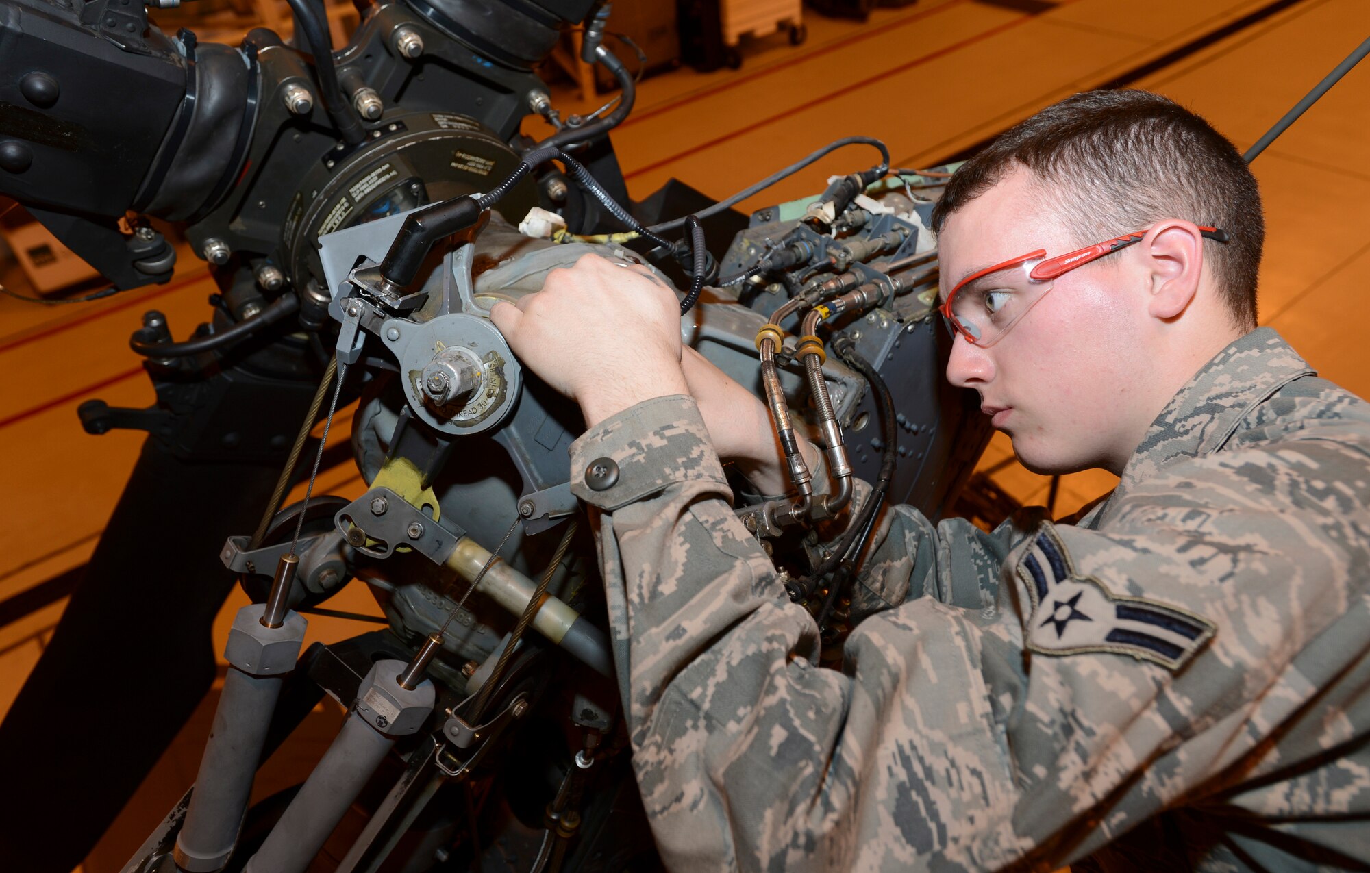 ROYAL AIR FORCE LAKENHEATH, England - Airman 1st Class Charles Lewis, 56th Helicopter Maintenance Unit crew chief, applies safety wire to an HH-60G Pave Hawk March 14, 2013. Lewis hails from Woodlawn, Va. Airmen of the 56th HMU recently completed phase maintenance on an HH-60G Pave Hawk in record time. (U.S. Air Force photo by Staff Sgt. Stephen Linch)