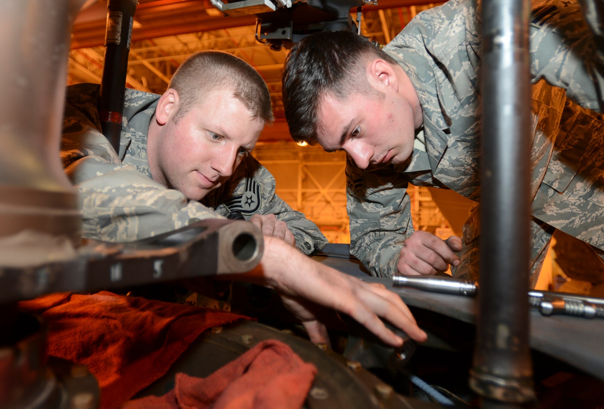 ROYAL AIR FORCE LAKENHEATH, England - Staff Sgt. Ryan Almy and Airman 1st Class Michael Vest, 56th Helicopter Maintenance Unit crew chiefs, change a bearing on an HH-60G Pave Hawk March 14, 2013. Almy is an Atlanta native and Vest hails from Hartselle, Ala. Airmen of the 56th HMU recently completed phase maintenance on an HH-60G Pave Hawk in record time.  (U.S. Air Force photo by Staff Sgt. Stephen Linch)