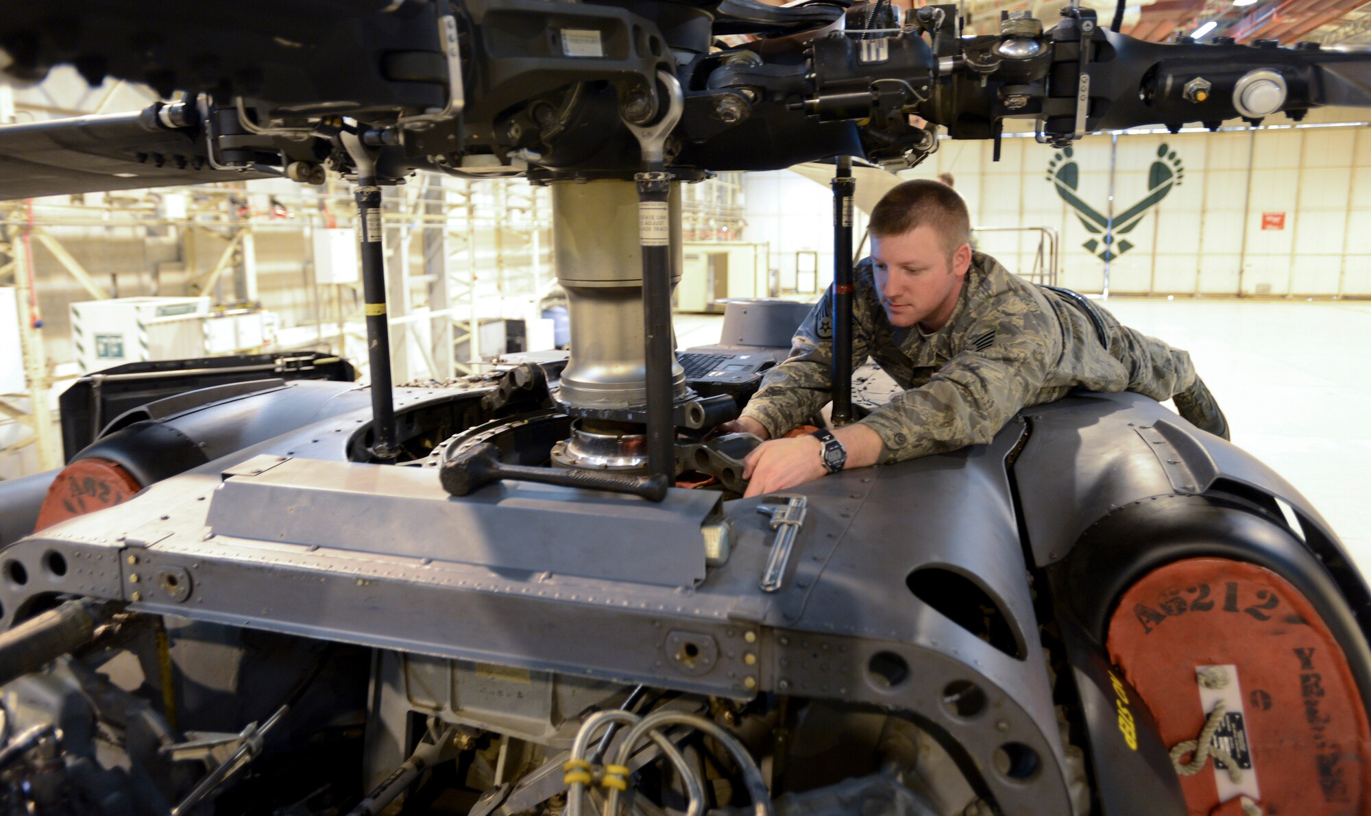 ROYAL AIR FORCE LAKENHEATH, England - Staff Sgt. Ryan Almy, 56th Helicopter Maintenance Unit crew chief and Atlanta native, changes a bearing on an HH-60G Pave Hawk March 14, 2013. Airmen of the 56th HMU recently completed phase maintenance on an HH-60G Pave Hawk in record time. (U.S. Air Force photo by Staff Sgt. Stephen Linch)