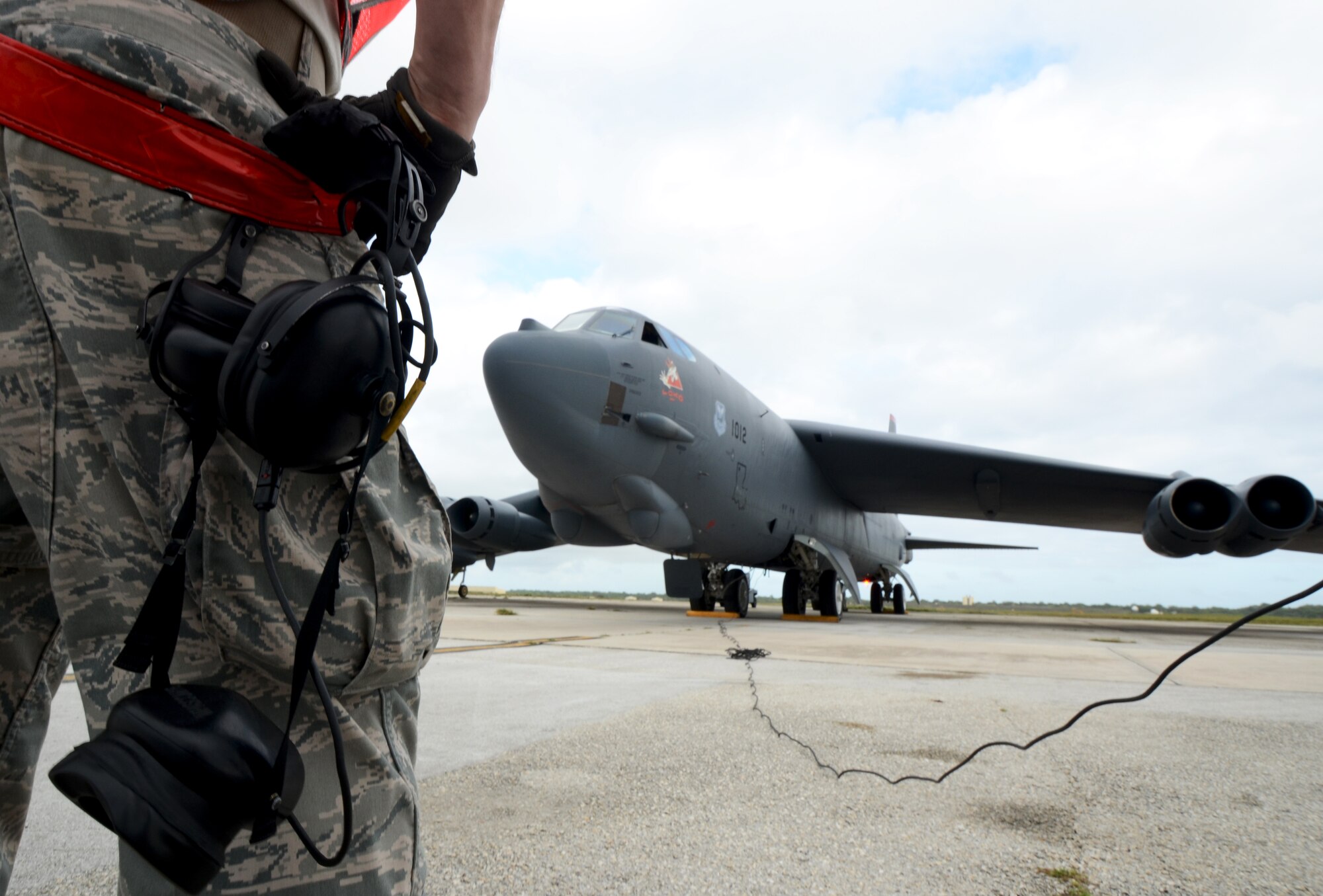 Airman 1st Class Kevin Carmel, 36th Expeditionary Aircraft Maintenance Squadron crew chief, deployed from Minot Air Force Base, N.D., prepares a B-52 Stratofortress for takeoff at Andersen Air Force Base, Guam, April 2, 2013. A new rotation of aircrews, maintenance personnel and aircraft arrived to Guam March 31 to replace the 96th Expeditionary Bomb Squadron in support of U.S. Pacific Command’s continuous bomber presence mission. (U.S. Air Force photo by Senior Airman Benjamin Wiseman/Released)