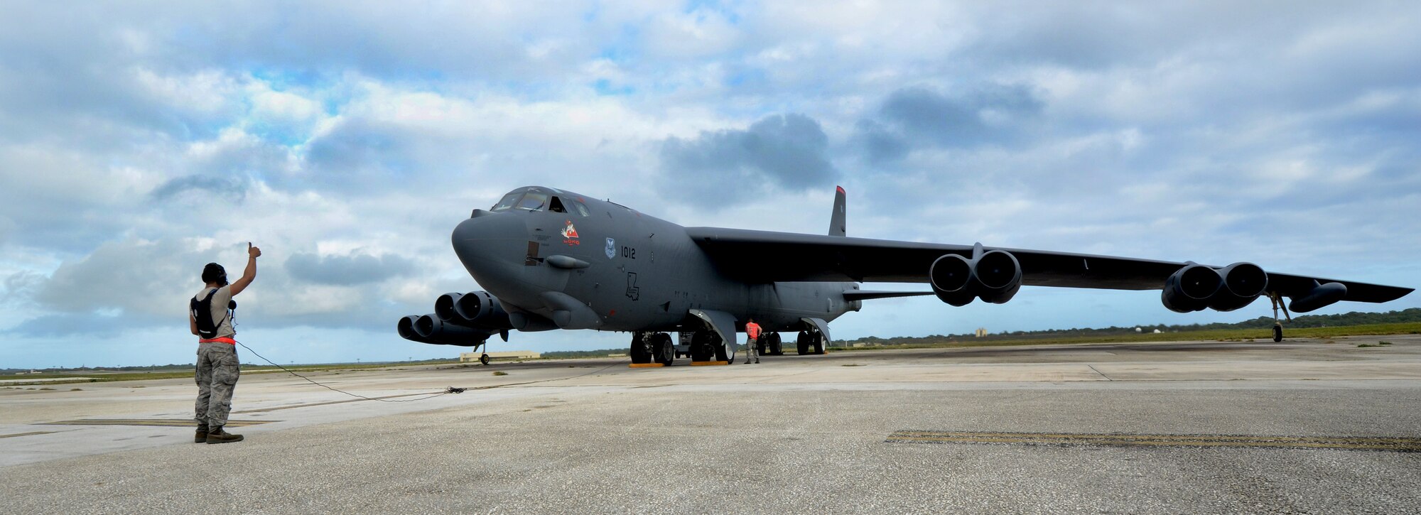 Airman 1st Class Julius Smith, 36th Expeditionary Aircraft Maintenance Squadron crew chief, deployed from Minot Air Force Base, N.D., prepares a B-52 Stratofortress for takeoff at Andersen Air Force Base, Guam, April 2, 2013. A new rotation of aircrews, maintenance personnel and aircraft arrived to Guam March 31 to replace the 96th Expeditionary Bomb Squadron in support of U.S. Pacific Command’s continuous bomber presence mission. (U.S. Air Force photo by Senior Airman Benjamin Wiseman/Released)