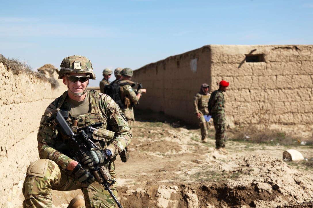U.S. Army Lt. Col. Scott Noon, front, provides security during an Afghan army-led gathering in Parwan province, Afghanistan, March 26, 2013. Noon is the commander of Division Headquarters and Headquarters Battalion, 101st Airborne Division.