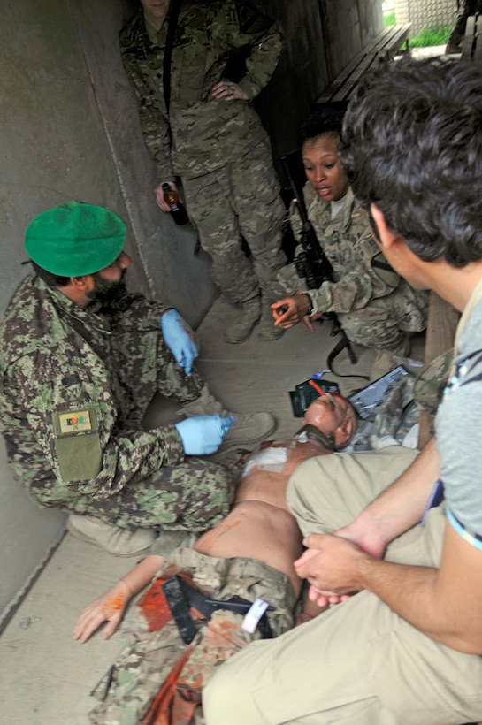 U.S. Army Staff Sgt. Kristal Wise, second from right, tells a ...