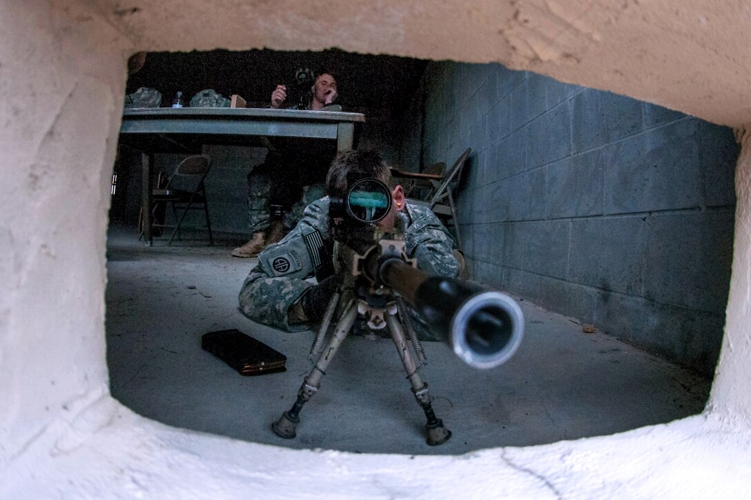 A scout sniper sights through the scope of his M110 semi-automatic sniper system on Fort Bragg, N.C., March 26, 2013.