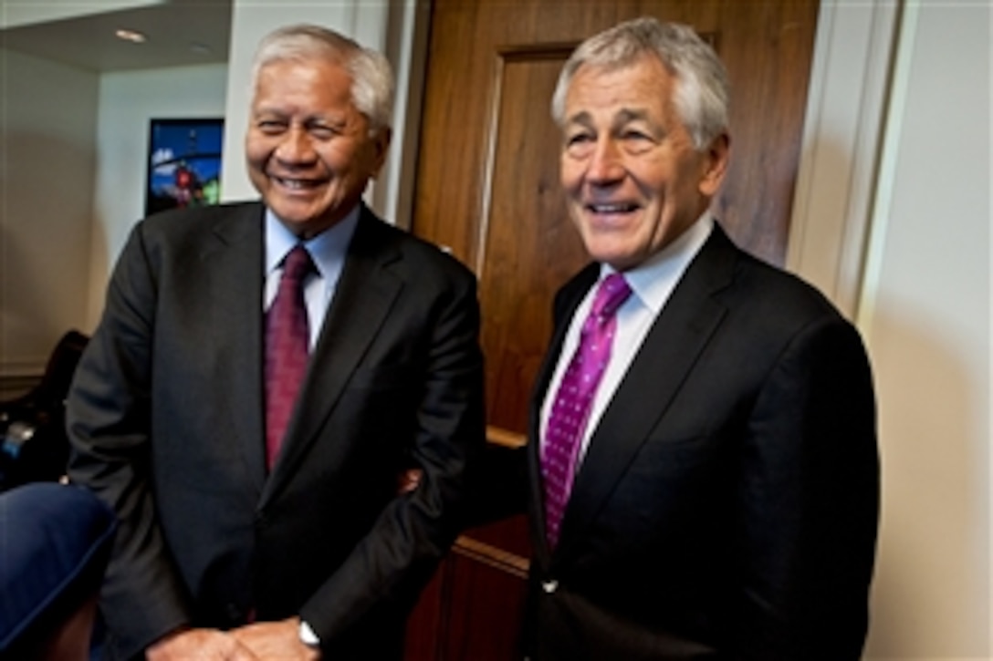 U.S. Defense Secretary Chuck Hagel, right, greets Philippine Foreign Secretary Albert F. Del Rosario before a meeting to discuss the U.S.-Philippine alliance at the Pentagon, April 2, 2013.