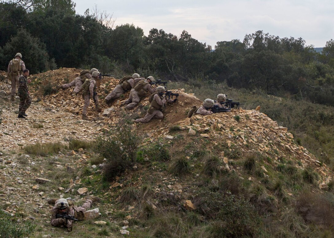 U.S. Marines and Sailors assigned to India Company, Battalion Landing Team 3/2, 26th Marine Expeditionary Unit (MEU), provide security from a berm while conducting a movement to contact exercise in tangent with French Legionnaires assigned to the 6th Light Armored Brigade, 2nd Foreign Legion Regiment, 5th Company, aboard Le Camp Des Garrigues, Nimes, France, March 27, 2013. The 26th MEU is deployed to the 6th Fleet area of operation. The MEU operates continuously across the globe, providing the president and unified combatant commanders with a forward-deployed, sea-based, quick-reaction force. The MEU is a Marine Air-Ground Task Force capable of conducting amphibious operations, crisis-response and limited contingency operations. (U.S. Marine Corps photo by Cpl. Kyle N. Runnels/Released)