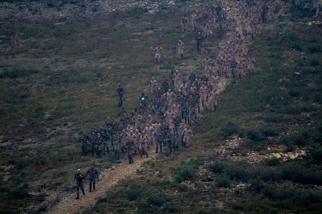 U.S. Marines and Sailors assigned to India Company, Battalion Landing Team 3/2, 26th Marine Expeditionary Unit (MEU), and French Legionnaires assigned to the 6th Light Armored Brigade, 2nd French Foreign Legion Regiment, 5th Company, participate in an Infernal Run aboard Le Camp Des Garrigues, Nimes, France, March 28, 2013. The Infernal Run consisted of a six kilometer obstacle course. The 26th MEU is deployed to the 6th Fleet area of operation. The MEU operates continuously across the globe, providing the president and unified combatant commanders with a forward-deployed, sea-based, quick-reaction force. The MEU is a Marine Air-Ground Task Force capable of conducting amphibious operations, crisis-response and limited contingency operations. (U.S. Marine Corps photo by Cpl. Kyle N. Runnels/Released)