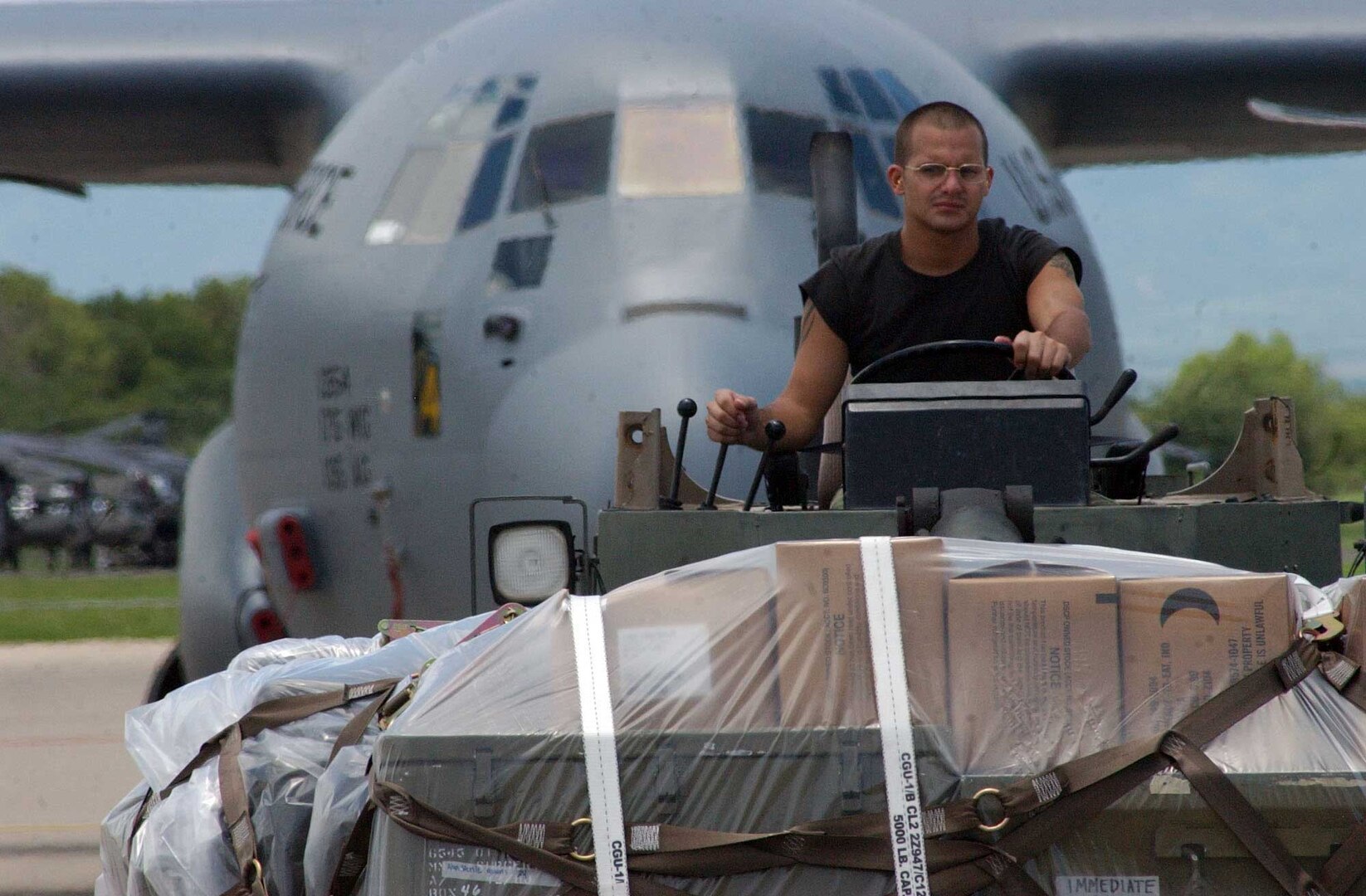 Senior Airman Kenneth Cumbie, 612th Air Base Squadron here, drives a forklift to load medical supplies onto a C-130J from the Maryland Air National Guard. Approximately 30 Soldiers and Airmen are responding to the Aug. 15 earthquake in Peru and are taking with them 4,470 pounds of medical supplies for relief efforts.