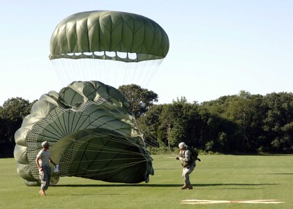 A competitor at the Rhode Island National Guard's international military parachute competition Leapfest XXV tries to collapse his parachute in the drop zone Aug. 11.