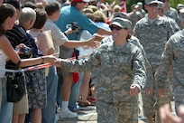 Family and friends greet U.S. Army Soldiers from Charlie Company, 1st Brigade Combat Team, 34th Infantry Division as they arrive at the Cottage Grove Armory in Minnesota July 16, 2007. Minnesota National Guard's 1st Brigade Combat Team has been deployed for 22 months with 16 months out of the deployment in a combat zone.