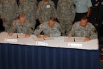 Director of Army National Guard Lt. Gen. Clyde Vaughn, Army Vice Chief of Staff Gen. Richard Cody and Lousiana Adjutant General and Chairman of the Adjutants General Association of the United States Force Structure Committee Maj. Gen. Bennett Landreneau sign a memorandum of understanding to formalize the Army plan to rebalance. The signing ceremony took place at the annual Association of the U.S. Army's annual conference in Washington.