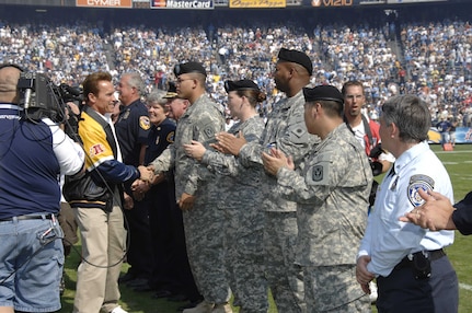 California Governor Arnold Schwarzenegger personally gives thanks to Pfc. Edgar Rivera, Pfc. Eliza Bealer, Sgt. Jerrod Dett, and Pfc Ryan Adams at the San Diego Chargers' Qualcomm Stadium Sunday, October 28, 2007.