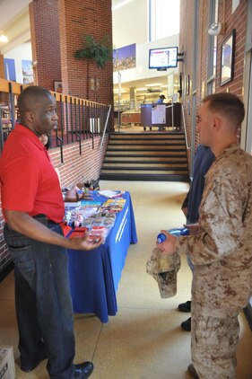 Milton Young, an alcohol abuse prevention specialist, talks to Lance Cpls. Jacob Musso and Jordan Rodriguez at Bruce Hall on April 1, 2013. Young was at the chow hall talking to Marines about alcohol awareness.