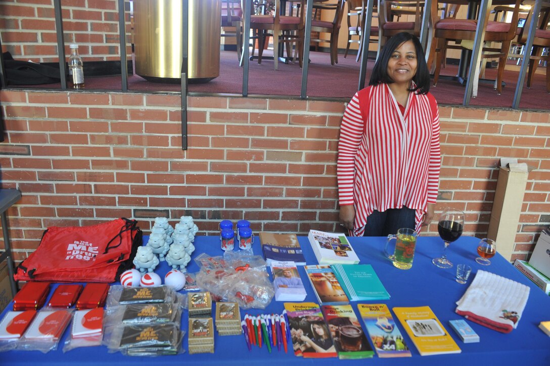 Rachel Jones, an administrative specialist, mans an alcohol awareness display at Bruce Hall on April 1, 2013. She gave away novelties that promoted safe drinking to those who passed her table.