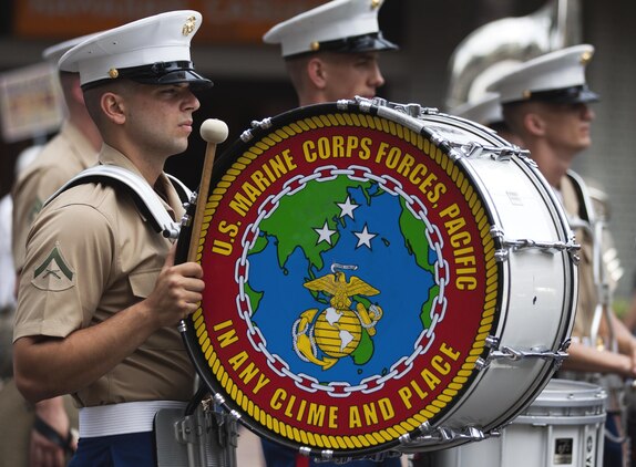 HONOLULU - Drum line Marines in the Marine Corps Forces, Pacific Band stand at rest as they wait to receive their next command during the 11th annual Prince Kuhio Commemoration Parade in Honolulu, March 23. The drum line performed several drum solos throughout the duration of the parade. (U.S. Marine Corps photo taken by Lance Cpl. Matthew Bragg)