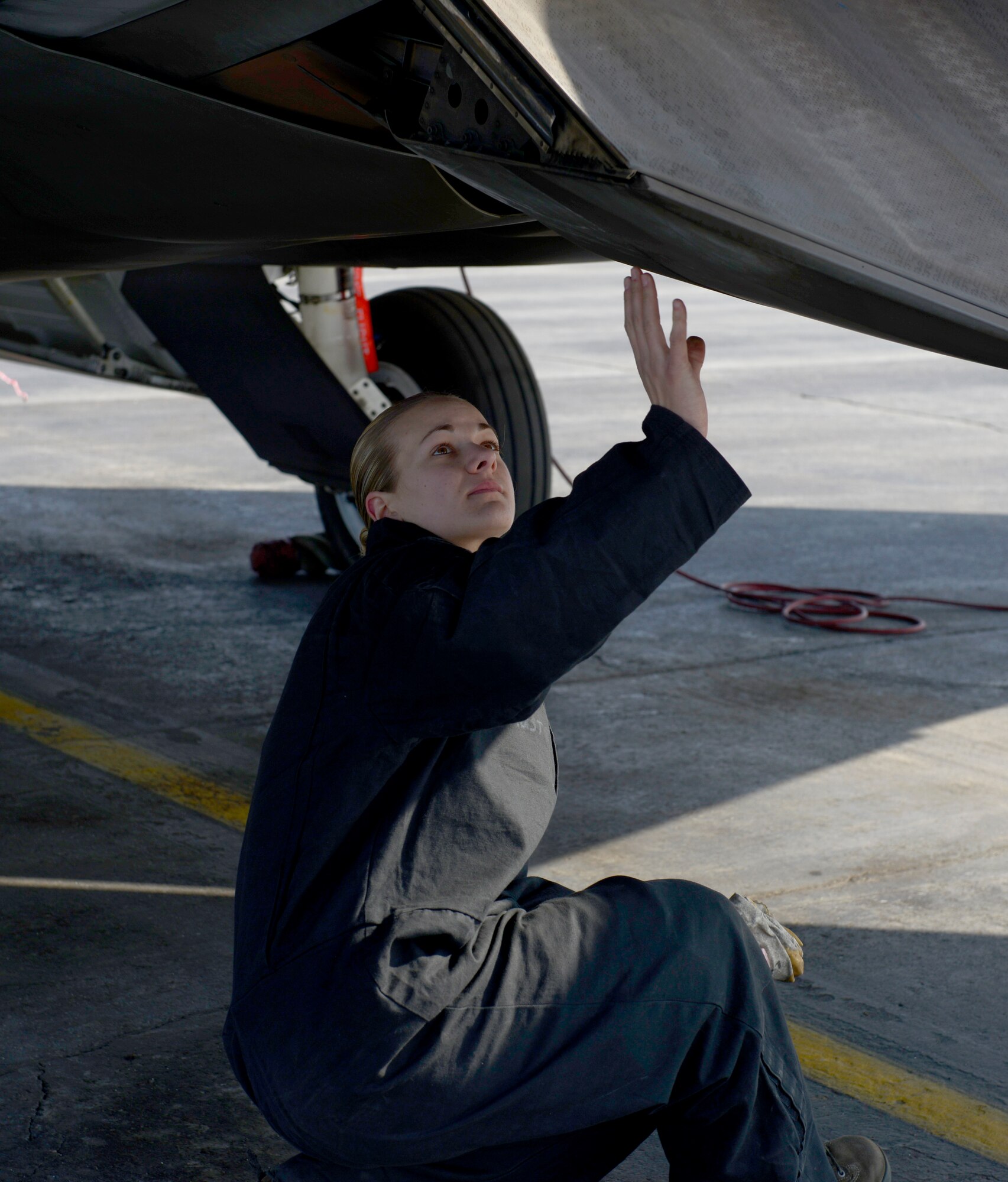 Crew chief, Senior Airman Jennifer Dunham from the 90th aircraft maintenance unit, inspects the exhaust of an F-22 Raptor in during Polar Force 13-3 Exercise on Joint Base Elmendorf-Richardson April 3. The exercise is designed to validate the wings' ability to integrate, mobilize, and prepare assigned personnel, aircraft and equipment for their wartime mission and to employ forces and weapons systems to perform tasked missions. (U.S. Air Force photo/ Airman 1st Class Tammie J. Ramsouer) 