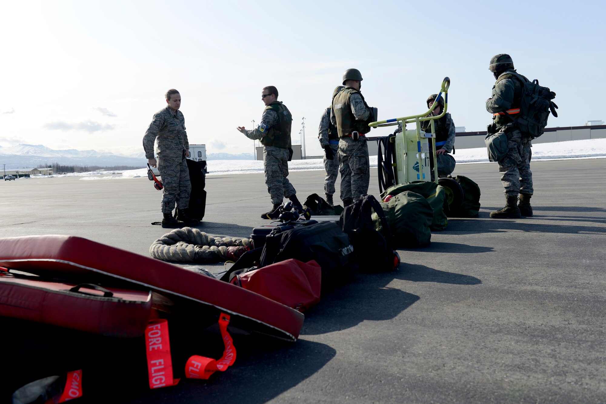 Airmen wait to taxi in F-22 Raptors as they arrive during Polar Force 13-3 Exercise on Joint Base Elmendorf-Richardson April 3. The exercise is designed to validate the wings' ability to integrate, mobilize, and prepare assigned personnel, aircraft and equipment for their wartime mission and to employ forces and weapons systems to perform tasked missions. (U.S. Air Force photo/ Airman 1st Class Tammie J. Ramsouer)