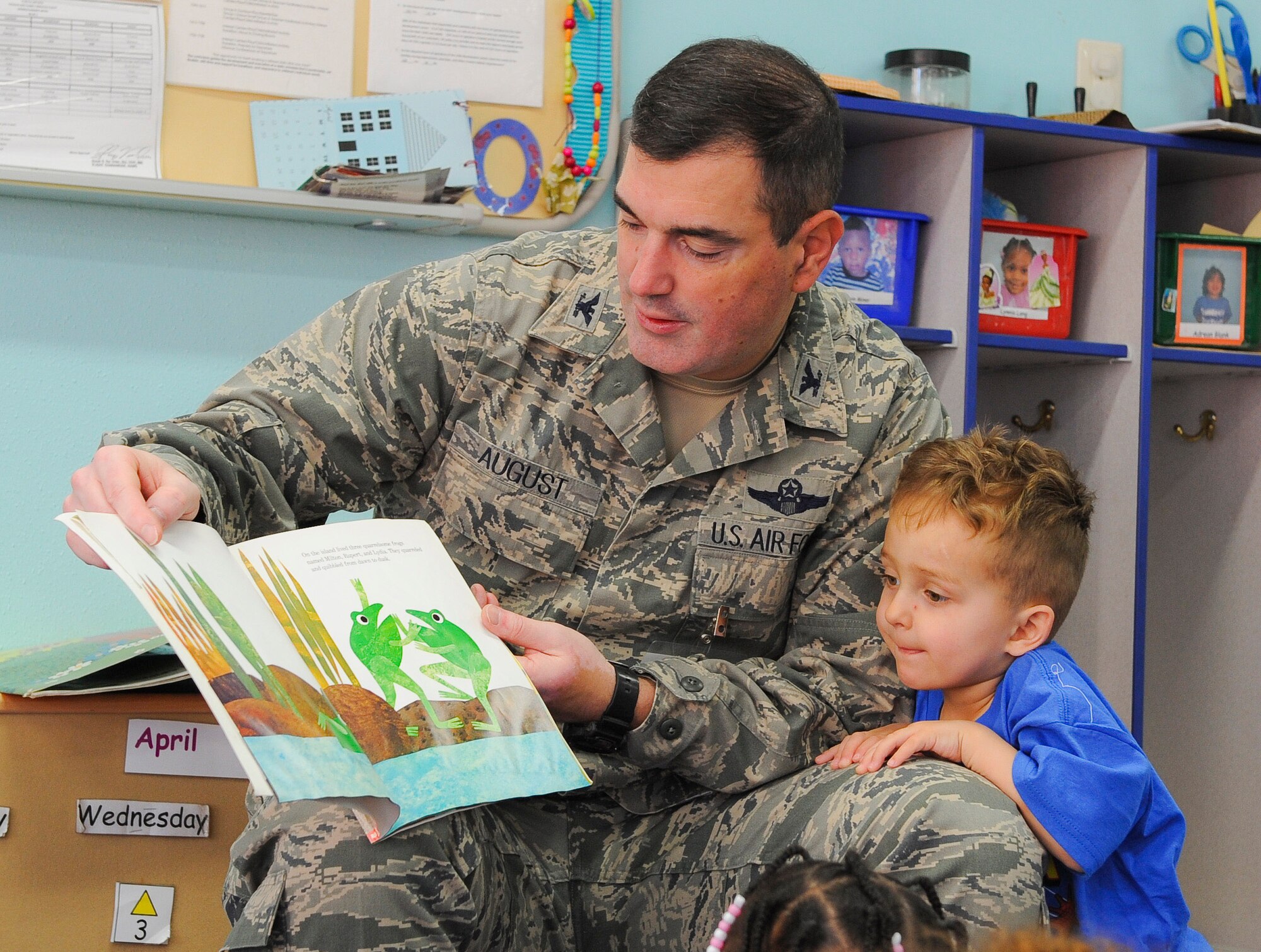 YOKOTA AIR BASE, Japan -- Col. Mark August, 374th Airlift Wing commander, reads to children as Keagan Kirk, son of Senior Airman Joseph Kirk, 374th Communications Squadron, leans in for a better view at the Yume Child Development Center at Yokota Air Base, Japan, April 4, 2013. Several base leaders are scheduled to read at other locations in support of the Month of the Military Child. (U.S. Air Force photo by Airman 1st Class Desiree Economides)