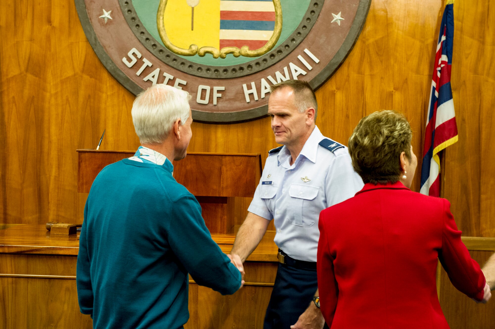 Kirk Caldwell, Honolulu city mayor, shakes hands with Col. Johnny Roscoe, 15th Wing commander, after the Sexual Assault Awareness Month proclamation and certificate ceremony in the city council chamber in Honolulu, Hawaii, April 2, 2013. The purpose of the event was to powerfully demonstrate the military and local community’s united stand against sexual assault. (U.S. Air Force photo/Staff Sgt. Terri Paden)