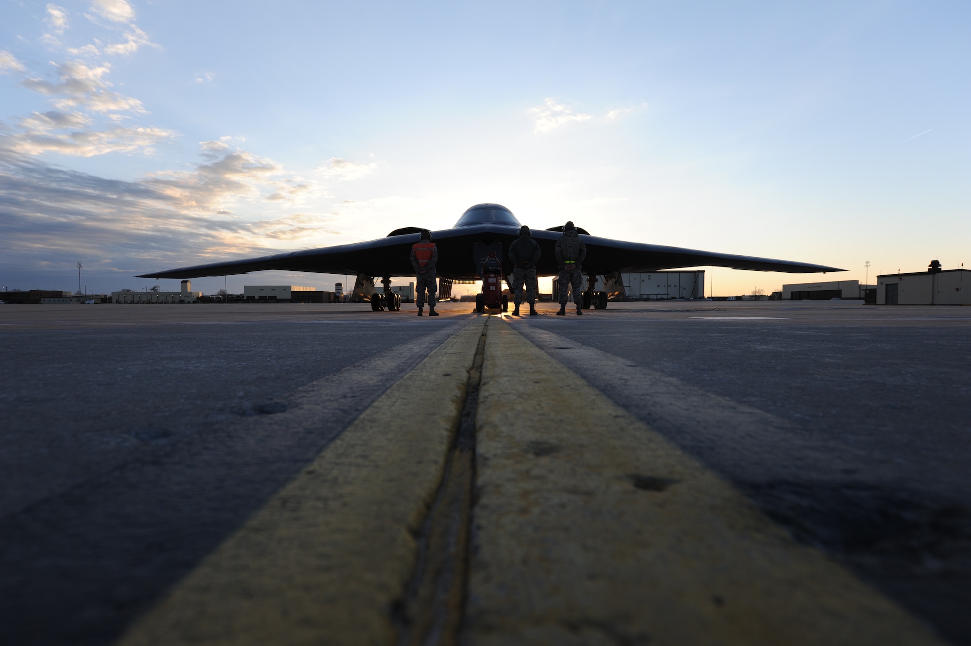 U.S. Air Force B-2 Spirit crew chiefs stand at parade rest while performing post flight inspections with pilots in the cockpit of the “Spirit of Florida” at Whiteman Air Force Base, Mo., April 1, 2013. The pilots just completed a historic training mission in which it became the first B-2 to reach 7,000 flight hours.   (U.S. Air Force photo by Staff Sgt. Nick Wilson/Released)