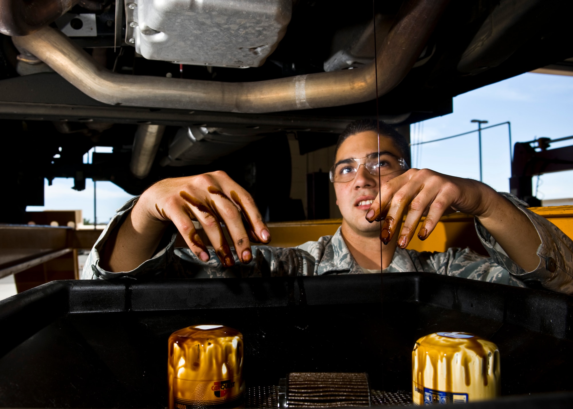 Airman 1st Class Bradley Kessinger, 99th Logistics Readiness Squadron vehicle maintenance specialist, changes the oil on a multi-stop truck April 4 at the 99th LRS maintenance hangar. Kessinger and fellow vehicle maintenance specialists ensure that government vehicles are kept to optimum performance. (U.S. Air Force photo by Senior Airman Brett Clashman)