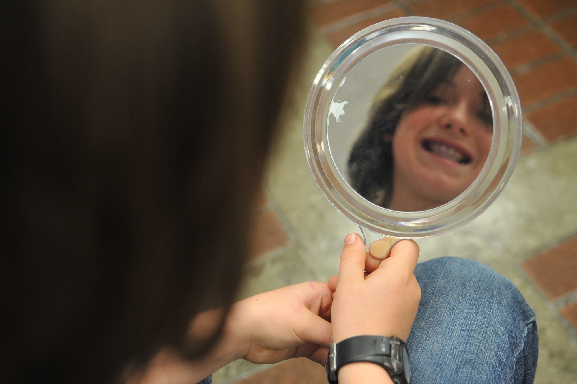 Matthew Bryant, 10, checks for plaque deposits after taking a plaque disclosing tablet during the Home School Dental Program held at the hospital on Osan Air Base, Republic of Korea, April 2, 2013. The plaque disclosing tablet allows individuals to identify plaque deposits in an effort to better their dental habits. (U.S. Air Force photo/Tech. Sgt. Raymond Mills) 