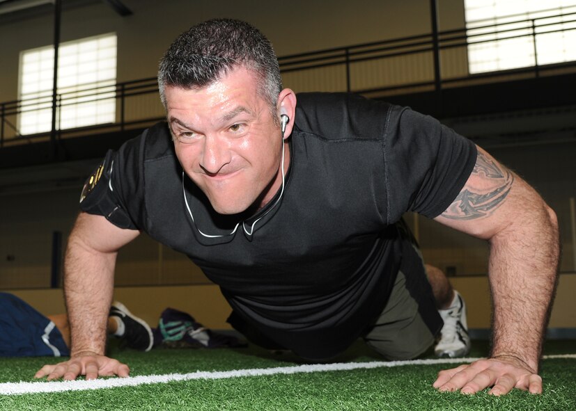 Master Sgt. Luis Vela, 319th Force Support Squadron first sergeant, tries to do as many push-ups as possible in 10 minutes during a push-up contest held March 29, 2013, at the Sports and Fitness Center indoor soccer field on Grand Forks Air Force Base, N.D. The push-up competition helped raise funds for the Grand Forks AFB 1st Sergeants' Council's various charitable projects and programs. (U.S. Air Force photo/Airman 1st Class Ashley Nicole Taylor)