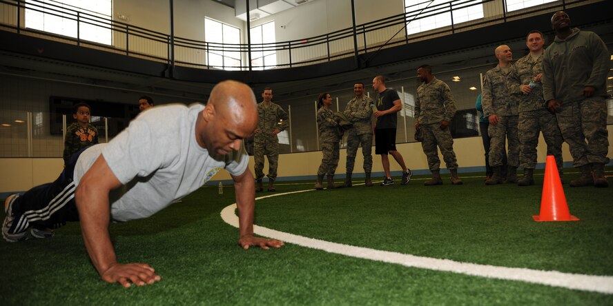 Maj. Johari Hemphill, 319th Logitsics Readiness Squadron commander, helps raise funds for the base's 1st Sergeants' Council charitable projects and programs by competiing in a push-up contest March 29, 2013, at the Sports and Fitness Center indoor soccer field on Grand Forks Air Force Base, N.D. Hemphill won the event by pumping out 442 push-ups in 10 minutes. (U.S. Air Force photo/Airman 1st Class Ashley Nicole Taylor)