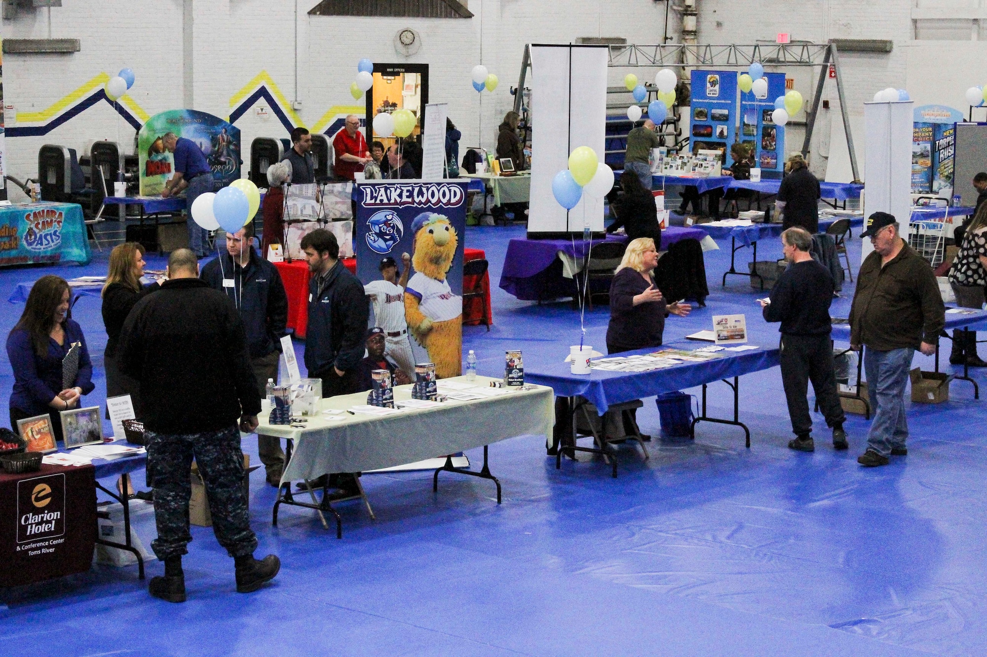 Joint base community members congregate at various tables at the Leisure and travel Show March 19, 2013, in the Lakehurst Fitness and Sports Center at Joint Base McGuire-Dix-Lakehurst, N.J. The two-day event, hosted by the 87th Force Support Squadron, allowed community members to peruse different representatives’ information on various travel and leisure opportunities. (U.S. Air Force courtesy photo/Released)
